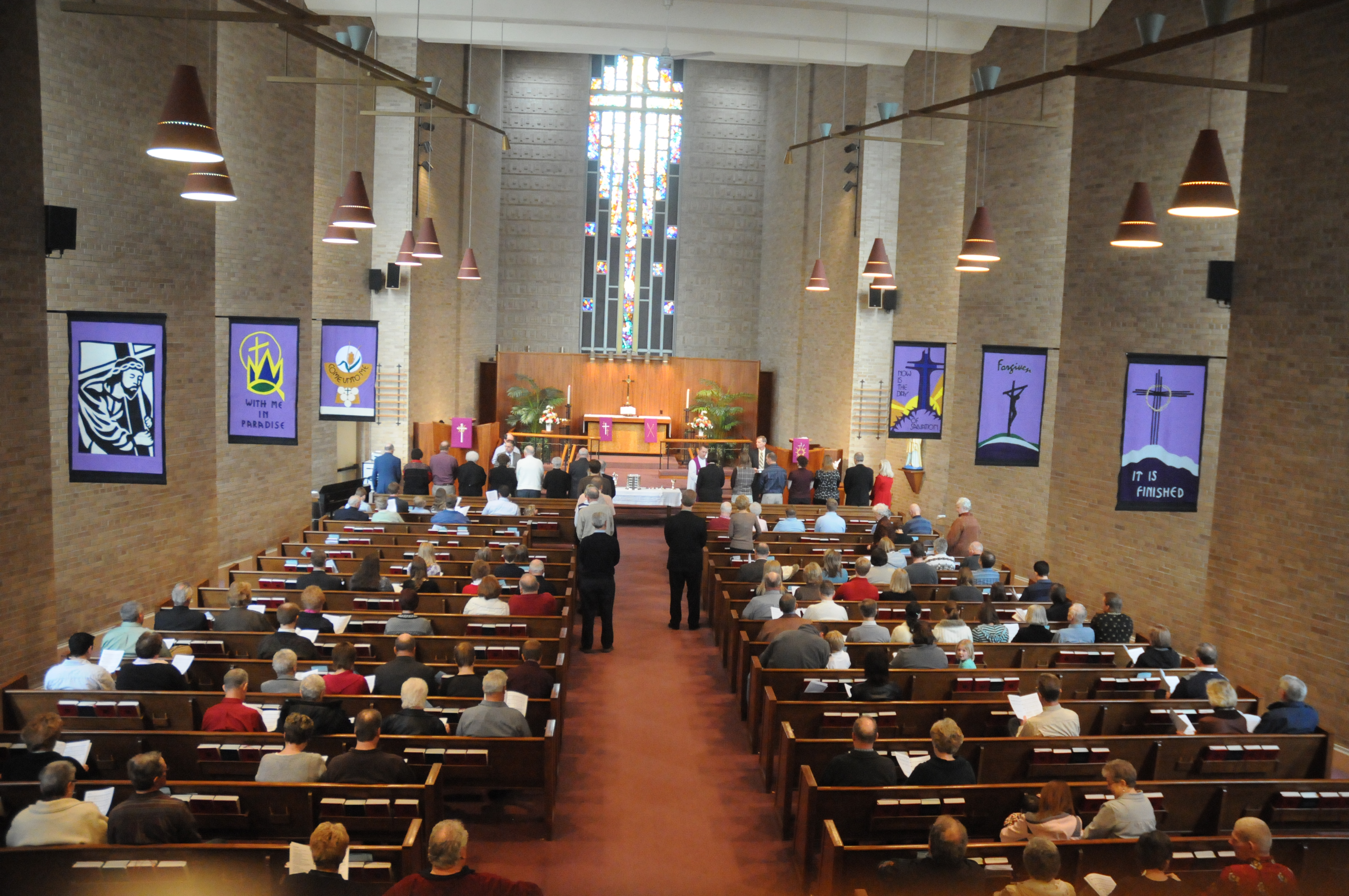 Communion during worship in North Saint Paul with Lenten banners